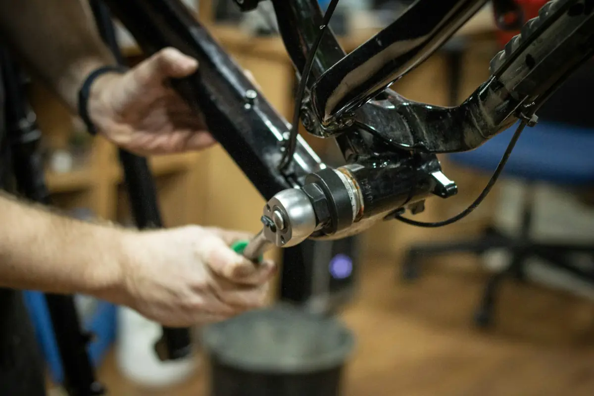 a close up of a mechanic working on a bike